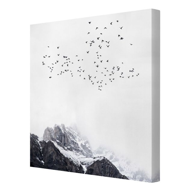 Canvas schilderijen Flock Of Birds In Front Of Mountains Black And White