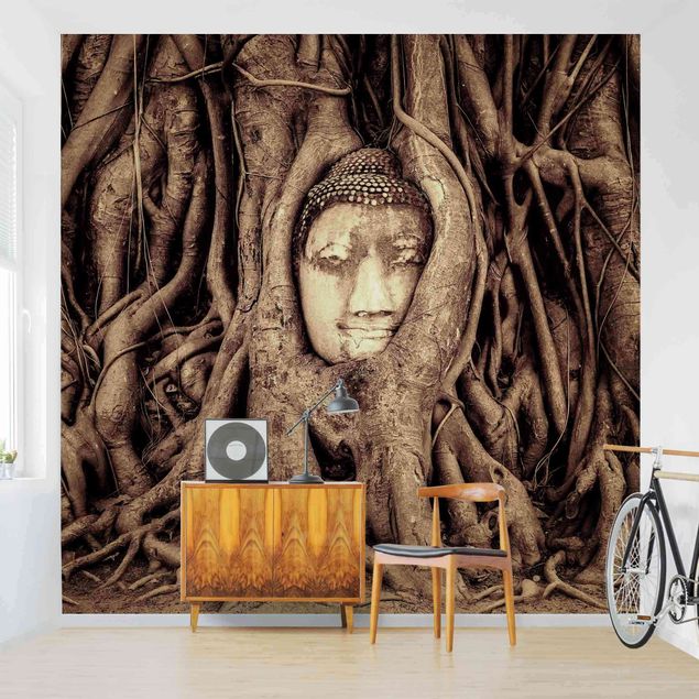 Fotobehang Buddha In Ayutthaya Lined From Tree Roots In Brown