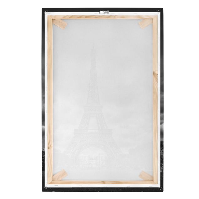 Canvas schilderijen Eiffel Tower In Front Of Clouds In Black And White