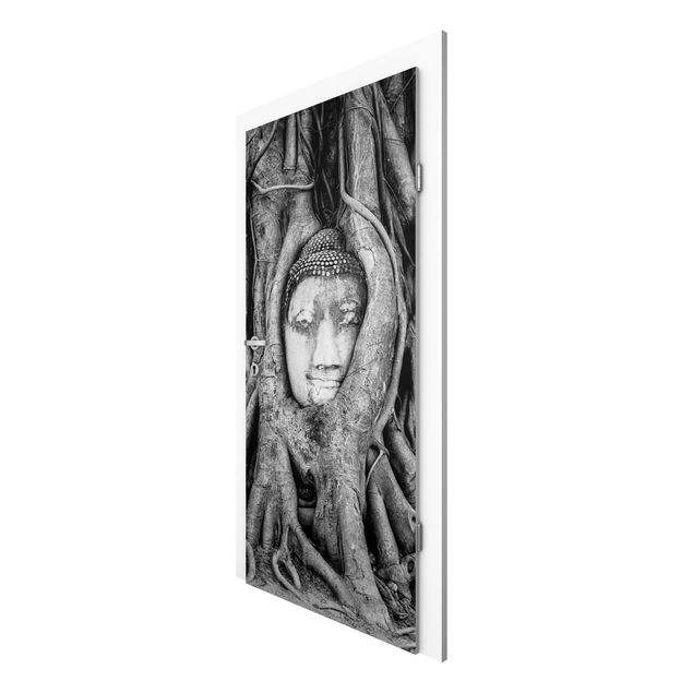 Deur behang Buddha In Ayutthaya Lined From Tree Roots In Black And White